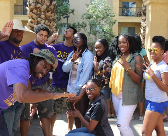 UCR ASP members hanging out in front of apartments.