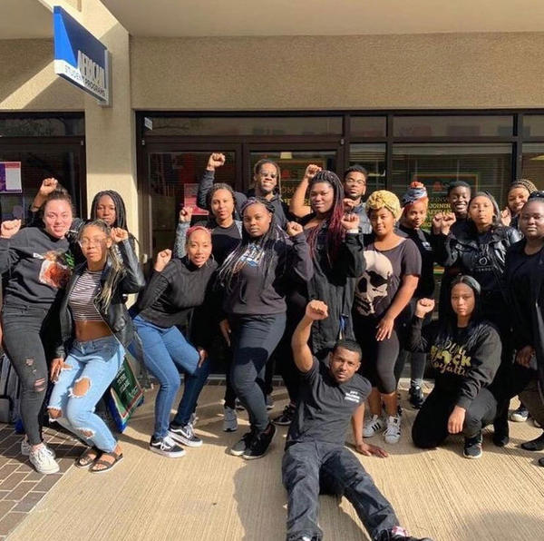 A group of students gather for a photo opportunity in front of the ASP center at Costo Hall