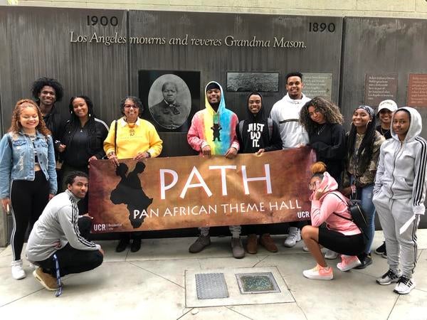 ASPs P.A.T.H. student take a group photo in front of Grandma Mason's memorial in Los Angeles