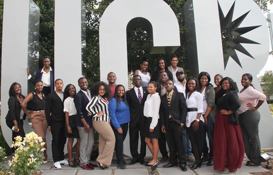 UCR ASP community gathered in front of metallic UCR sign.